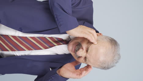 Vertical-video-of-Old-businessman-with-headache.